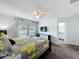 Bright bedroom featuring neutral paint, ceiling fan, and an ensuite bathroom with a double-sink vanity at 394 Orange Cosmos Blvd, Davenport, FL 33837