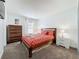 Cozy bedroom featuring a wooden bed frame, matching dresser and nightstand, with soft carpet at 394 Orange Cosmos Blvd, Davenport, FL 33837