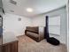 A bedroom with a wooden bunk bed, soft carpet, and plenty of natural light coming through the blinds at 394 Orange Cosmos Blvd, Davenport, FL 33837