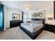 Bedroom with a black platform bed, modern lamps, and a striking motorcycle art piece at 394 Orange Cosmos Blvd, Davenport, FL 33837