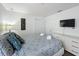 The modern bedroom featuring ample closet space, a flat-screen television, and a calming color scheme at 394 Orange Cosmos Blvd, Davenport, FL 33837