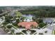 Aerial view of the community center with a pool, lush landscaping, and a picturesque lake at 394 Orange Cosmos Blvd, Davenport, FL 33837