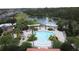 Aerial view of the community pool, playground, and scenic pond providing resort-style amenities at 394 Orange Cosmos Blvd, Davenport, FL 33837