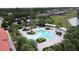 Aerial view of the community pool area, complete with pergolas, lush landscaping, and comfortable seating at 394 Orange Cosmos Blvd, Davenport, FL 33837