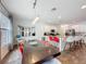 Dining room features a modern light fixture, table setting and access to kitchen bar seating at 394 Orange Cosmos Blvd, Davenport, FL 33837