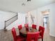 Stylish dining room with a round table, seating for six, and staircase view at 394 Orange Cosmos Blvd, Davenport, FL 33837