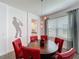 Dining room featuring a round table, red chairs, and decorative lighting at 394 Orange Cosmos Blvd, Davenport, FL 33837