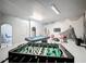 Finished basement game room with a pool table, foosball table, bar stools and Star Wars themed mural at 394 Orange Cosmos Blvd, Davenport, FL 33837
