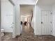 Hallway leads to the front door, living area and bathroom with tile floors throughout at 394 Orange Cosmos Blvd, Davenport, FL 33837