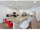 Open kitchen with white cabinets, granite countertops, and eat-in breakfast bar at 394 Orange Cosmos Blvd, Davenport, FL 33837