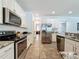 Well-equipped kitchen with stainless steel appliances and granite countertops at 394 Orange Cosmos Blvd, Davenport, FL 33837