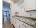 Kitchen showcasing white cabinets, granite counters, and modern finishes at 394 Orange Cosmos Blvd, Davenport, FL 33837