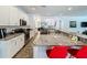 Bright kitchen boasts granite counters, stainless appliances, and breakfast bar at 394 Orange Cosmos Blvd, Davenport, FL 33837