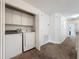 A convenient laundry room features a washer, dryer and cabinet space at 394 Orange Cosmos Blvd, Davenport, FL 33837