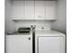 Convenient laundry room with a modern washer and dryer, and built-in cabinetry for storage at 394 Orange Cosmos Blvd, Davenport, FL 33837