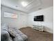 The living room is cozy with a futon sofa, a TV and access to two doors at 394 Orange Cosmos Blvd, Davenport, FL 33837