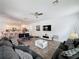 Open-concept living area features tile floors, comfortable couches, and updated furnishings at 394 Orange Cosmos Blvd, Davenport, FL 33837