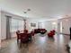 Open living and dining area with modern decor, tile floors, and bright windows at 394 Orange Cosmos Blvd, Davenport, FL 33837