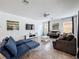 Spacious living room with comfortable seating, a ceiling fan, and a large screen television at 394 Orange Cosmos Blvd, Davenport, FL 33837
