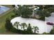 Aerial view of a community sand volleyball court and playground surrounded by mature landscaping at 394 Orange Cosmos Blvd, Davenport, FL 33837