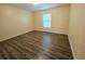 Bedroom with new flooring and a window at 5451 Vineland Rd # 111, Orlando, FL 32811