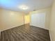 This bedroom features modern flooring and a spacious closet at 5451 Vineland Rd # 111, Orlando, FL 32811