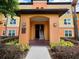 Inviting condo entrance with stairs, well-lit entryway, and a directory for easy navigation at 5451 Vineland Rd # 111, Orlando, FL 32811