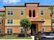 Charming multi-story condo building with a terracotta roof, stylish architecture, and well-maintained landscaping at 5451 Vineland Rd # 111, Orlando, FL 32811