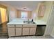 A view of a kitchen countertop with a stainless steel dishwasher and sink at 5451 Vineland Rd # 111, Orlando, FL 32811