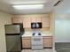 Kitchen with stainless steel refrigerator and a clean stove at 5451 Vineland Rd # 111, Orlando, FL 32811