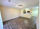 Spacious living room featuring modern flooring and a view of the kitchen at 5451 Vineland Rd # 111, Orlando, FL 32811