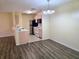 Open-concept living and dining area with hardwood floors, offering an airy and flexible living space at 5451 Vineland Rd # 111, Orlando, FL 32811