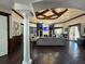 A luxurious living space features a coffered ceiling and an elegant chandelier at 5451 Vineland Rd # 111, Orlando, FL 32811