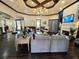 Cozy lounge area with comfortable seating, a fireplace, and a chandelier at 5451 Vineland Rd # 111, Orlando, FL 32811