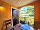 A porch with a view of the green space and a cozy seating area at 5451 Vineland Rd # 111, Orlando, FL 32811
