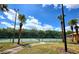 Well-maintained community tennis court surrounded by palm trees, perfect for recreational play at 5451 Vineland Rd # 111, Orlando, FL 32811