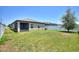 Well maintained backyard with a lawn, white fence, and screened in lanai providing privacy and space at 5816 Beefmaster Rd, St Cloud, FL 34771