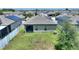 Private backyard with green lawn, fenced perimeter, and partially covered patio at 5816 Beefmaster Rd, St Cloud, FL 34771