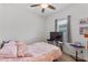 Cozy bedroom with a ceiling fan and a window for natural light at 5816 Beefmaster Rd, St Cloud, FL 34771