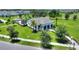 Community clubhouse featuring a covered porch, manicured lawns, and mature trees at 5816 Beefmaster Rd, St Cloud, FL 34771