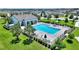 Community pool with lounge chairs, umbrellas, and lush landscaping at 5816 Beefmaster Rd, St Cloud, FL 34771