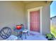Cozy front porch featuring a decorative welcome mat, seating and a beautifully painted front door at 5816 Beefmaster Rd, St Cloud, FL 34771
