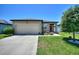 Attractive single-Gathering home with a neat front yard, two-car garage, and welcoming curb appeal at 5816 Beefmaster Rd, St Cloud, FL 34771