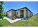 Inviting front porch with seating, adorned with colorful flowers and tasteful landscaping at 5816 Beefmaster Rd, St Cloud, FL 34771