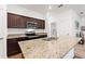 Modern kitchen with granite countertops, stainless steel appliances, and rich wood cabinetry at 5816 Beefmaster Rd, St Cloud, FL 34771