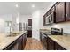 Modern kitchen featuring stainless steel appliances, granite countertops, and dark cabinetry at 5816 Beefmaster Rd, St Cloud, FL 34771