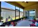 Relaxing screened lanai featuring a ceiling fan, sliding glass door access, and a view of the backyard at 5816 Beefmaster Rd, St Cloud, FL 34771