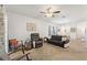 Spacious living room with ceiling fan, plush carpeting, and comfortable seating arrangement at 5816 Beefmaster Rd, St Cloud, FL 34771