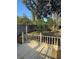 Cozy backyard deck with wooden railing overlooks the landscaped backyard with lush greenery and a wooden fence at 585 Mourning Dove Cir, Lake Mary, FL 32746