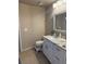 Bathroom featuring white vanity, granite countertop, tiled flooring and decorative mirror at 585 Mourning Dove Cir, Lake Mary, FL 32746